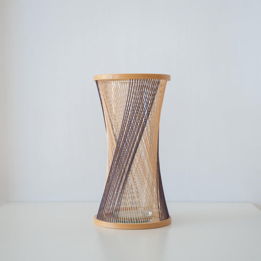Handcrafted Japanese bamboo Ikebana vase, meticulously crafted by skilled artisans using traditional bamboo weaving techniques, showcasing the natural beauty and elegance of bamboo.