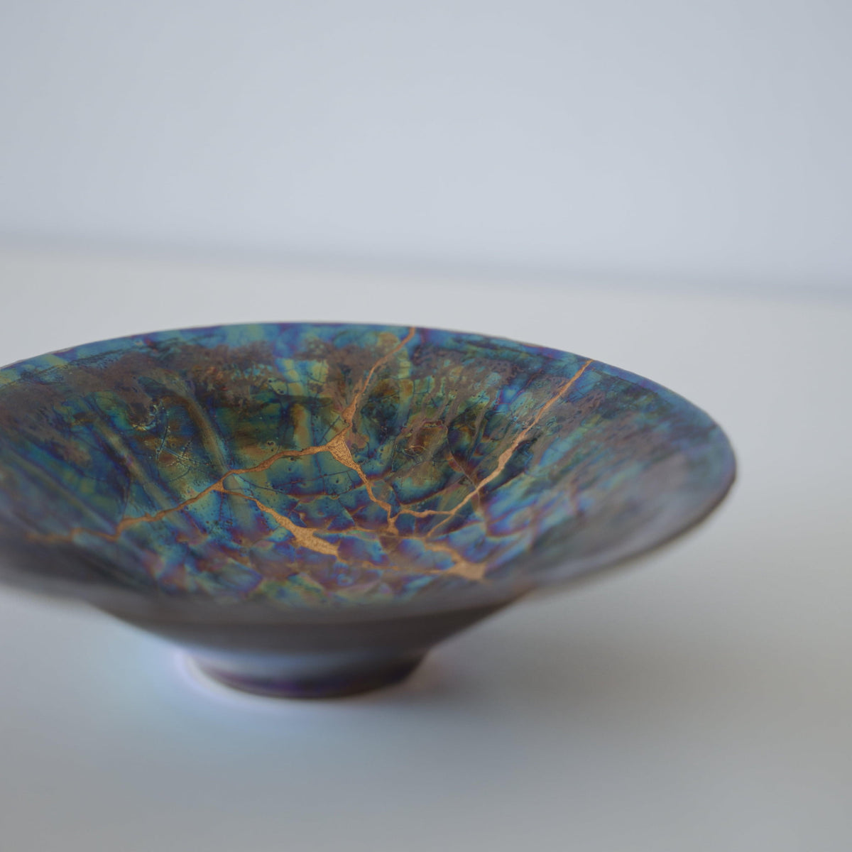 Close-up of Kintsugi Bowl "Blue Moon" side, highlighting the intricate Kintsugi repairs