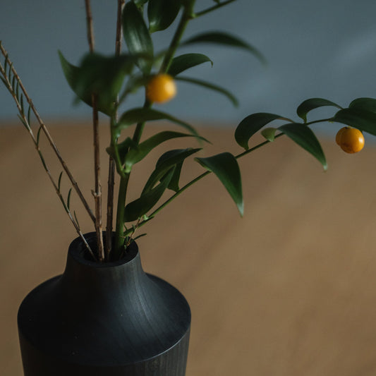 Japanese Cedar Ikebana Vase Indigo 02 in navy styled in a dining room setting, dining scene view.