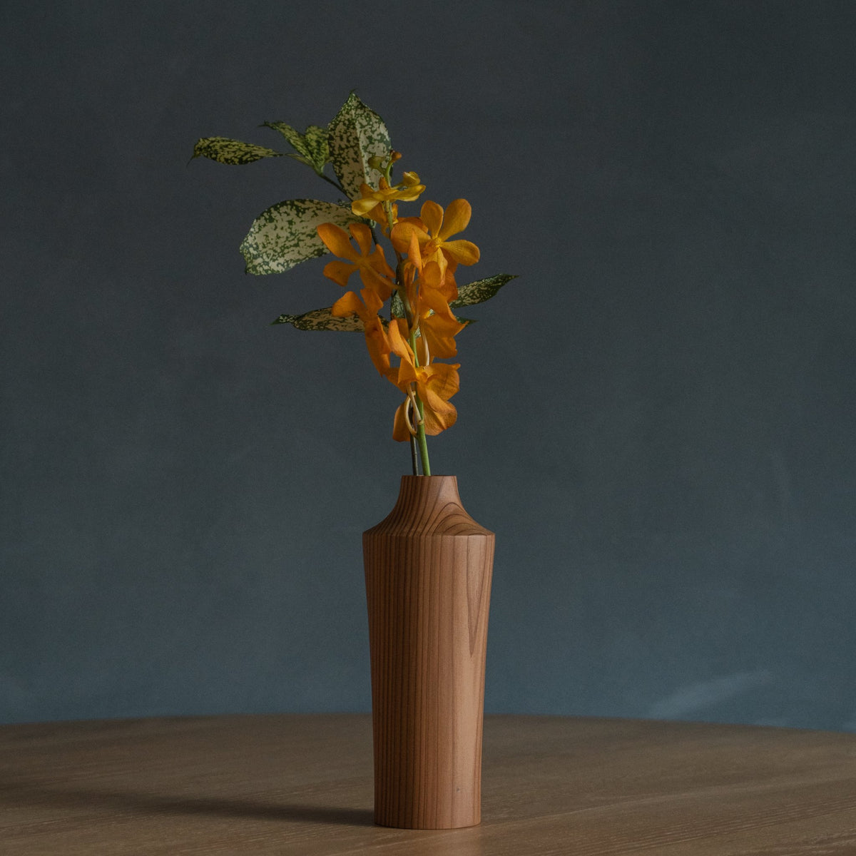 Japanese Cedar Ikebana Vase Natural Wood 02 in brown styled in a dining room setting, dining scene view.
