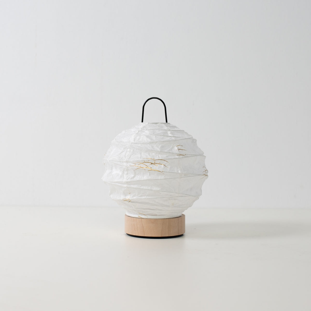 Japanese Paper Table Lamp "Yuhi" Rabbit, white, Mino Washi paper and wood - unlit round accent lamp from Japan on a white surface.