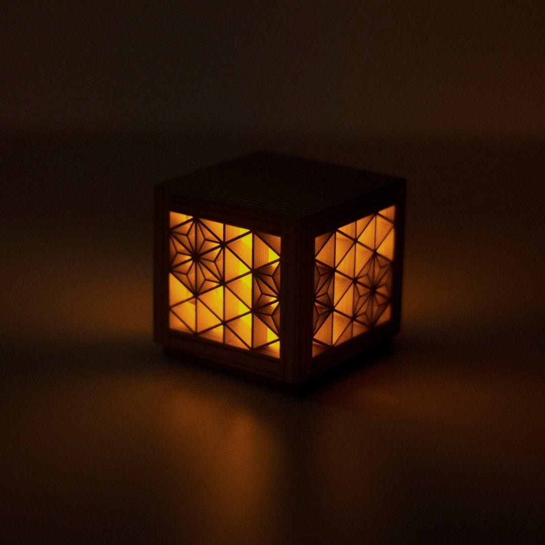 A kumiko lamp, highlighting the beautiful patterns created by the interlocking wooden pieces.