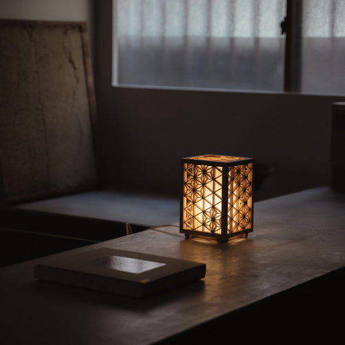 Japanese Kumiko Lantern "Asanoha" small on a wood table in a dimly room