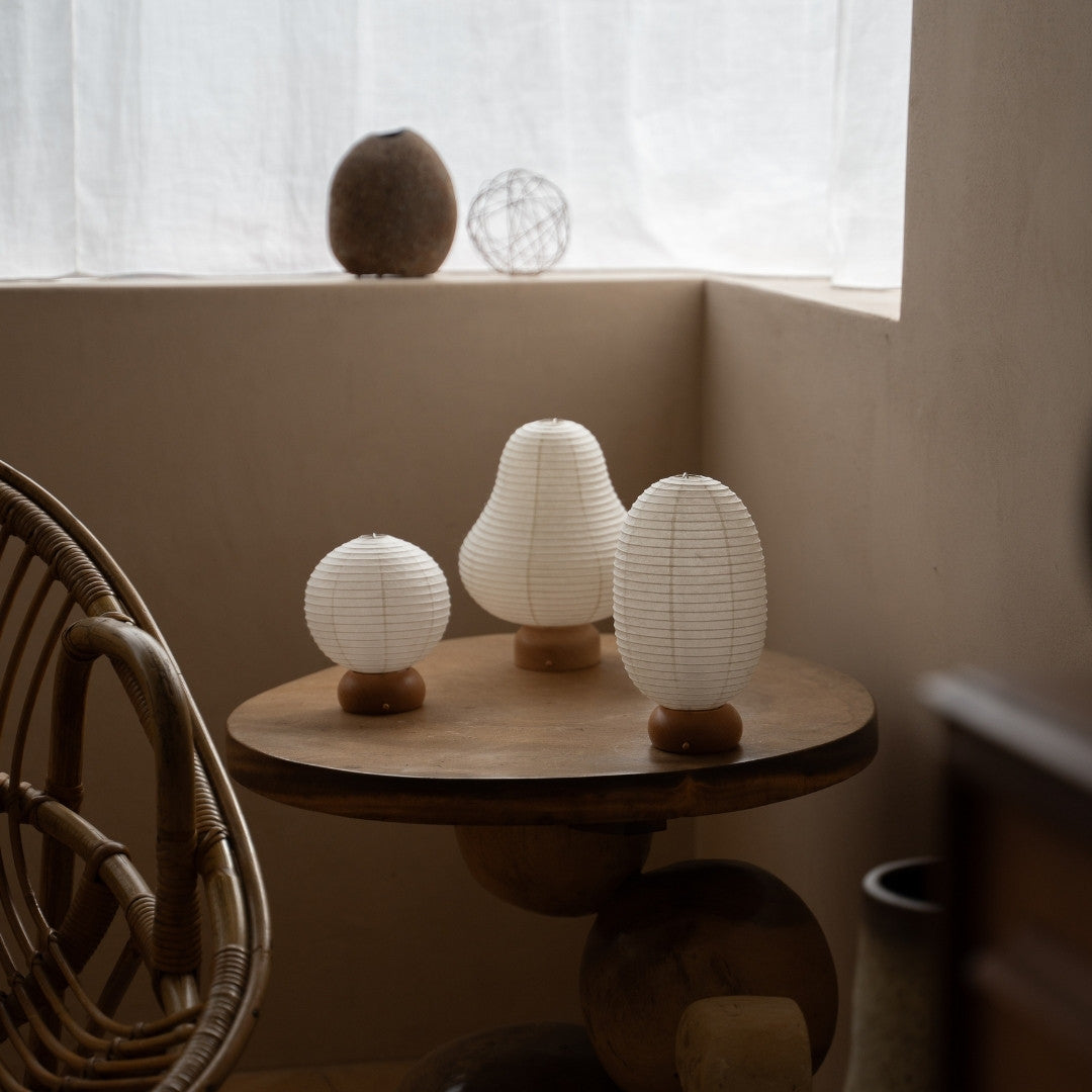 Three Japanese Paper Table Lamps on A Wooden Side Table in Japandi Living Room