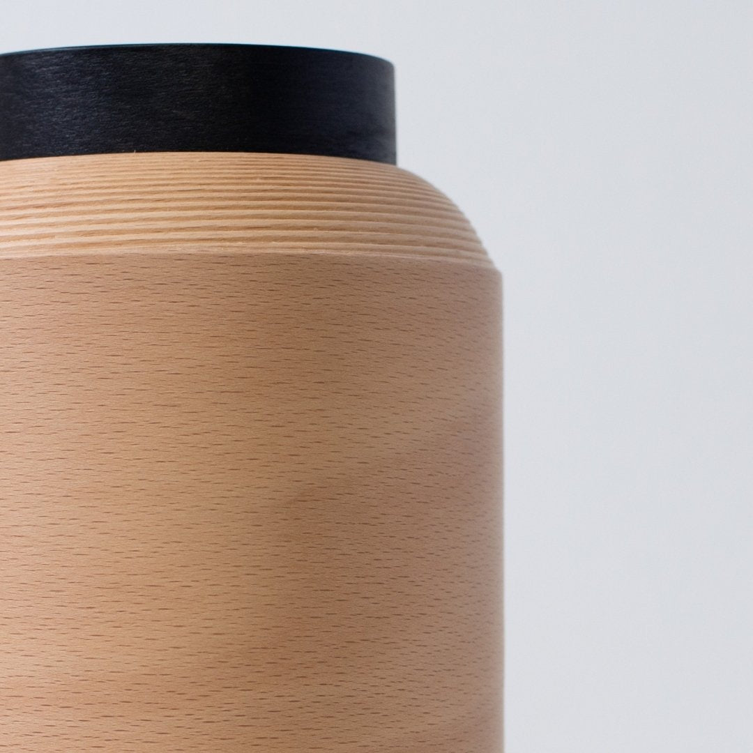 Close-up van een houten lamp met fijne beukenhoutnerf, met de hand vervaardigd in Japan volgens de BUNACO-techniek.