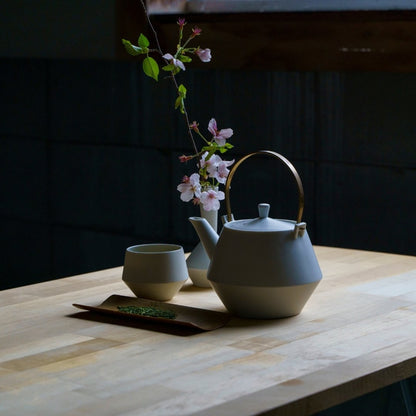 Japansk tekande sæt med yunomi tekopper og kirsebærblomster på træbord