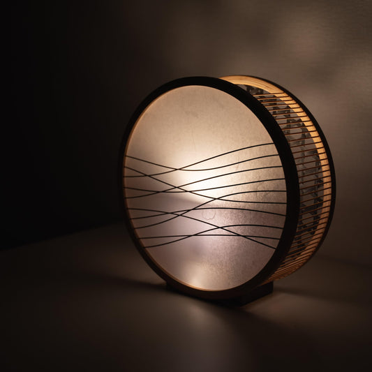 Traditional Japanese bamboo lamp handcrafted in Shizuoka with 800-year-old techniques. Circular wooden frame with washi paper shade featuring delicate bamboo accents. 