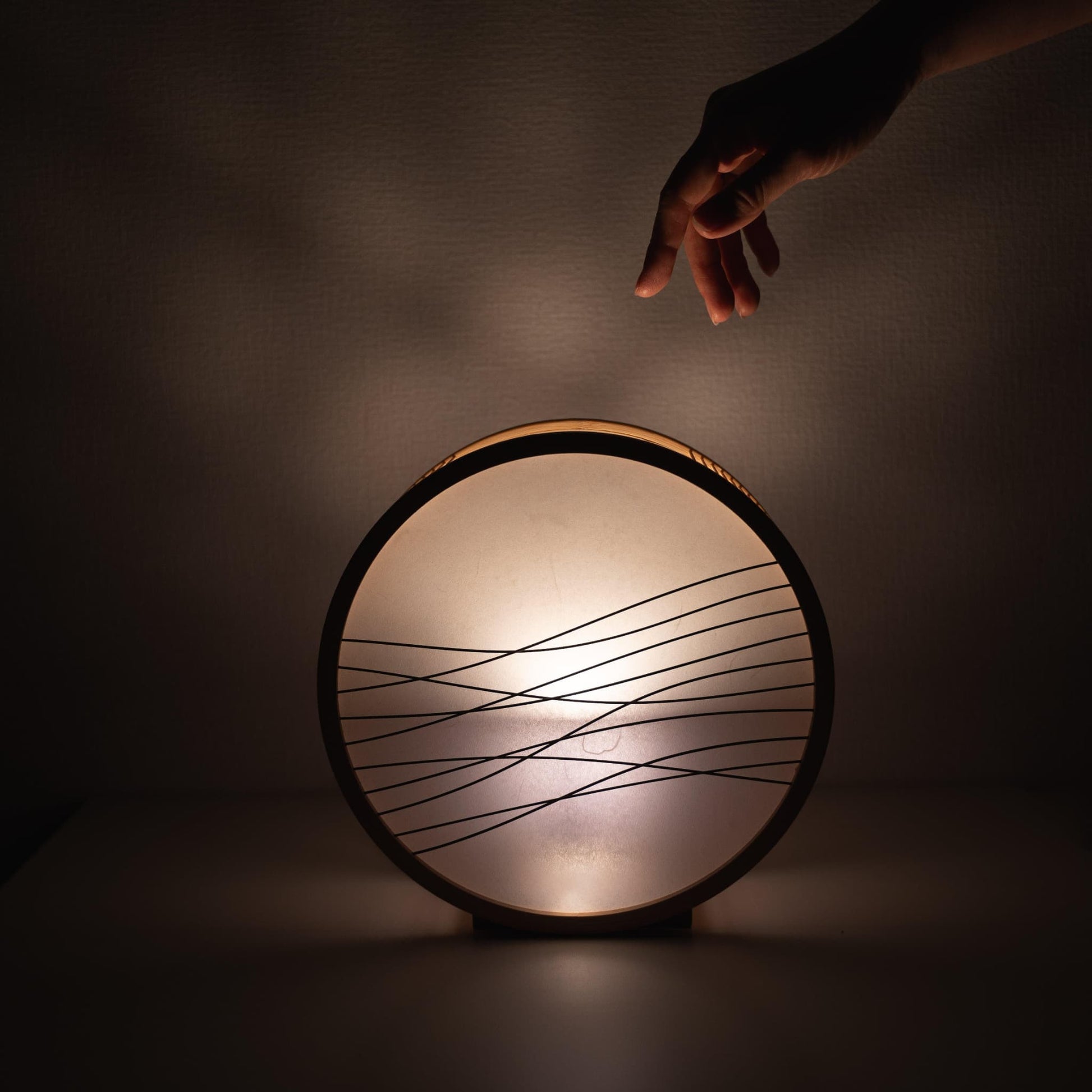Japanese bamboo floor lamp with a hand