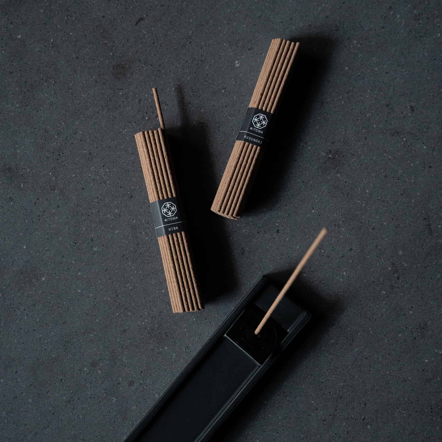 Japanese incense sticks and black incense plate on a table
