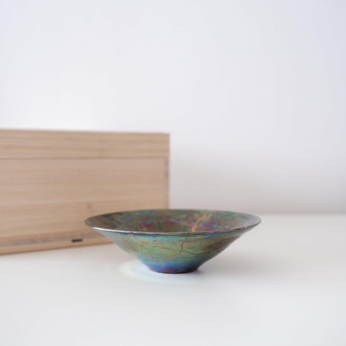 Coffret cadeau composé d'une coupe à saké vert profond réparée avec la technique traditionnelle japonaise du Kintsugi, et d'une boîte en bois de paulownia.