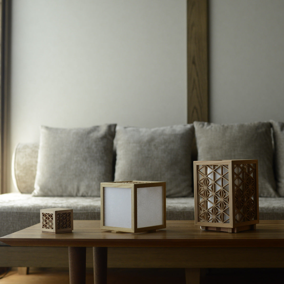 Kumiko table lamps and lanterns on a table in Japandi living room. 