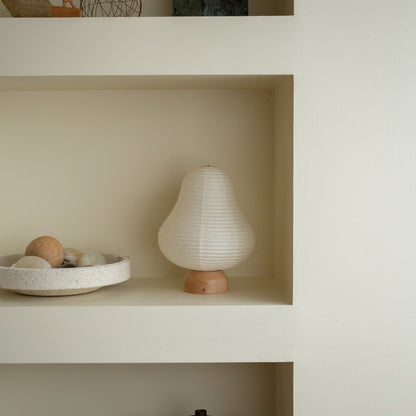 Japanese Paper Table Lamp "Mountain" on a white shelf in Japandi style room – Unique portable lamps for Japandi living room