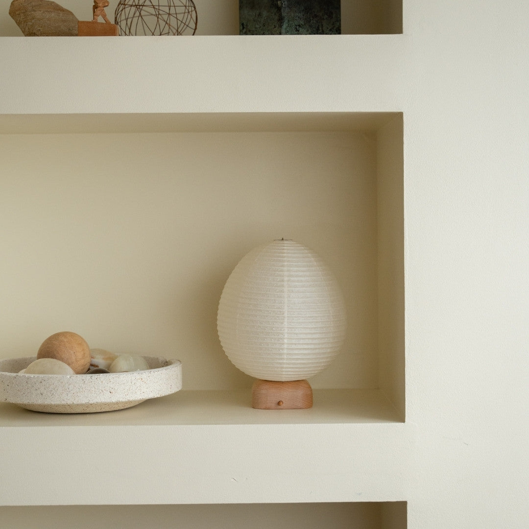 Japanese Paper Table Lamp "Ostrich" on a white shelf in Japandi style living room – Wabi-Sabi night lamp for bedside tables