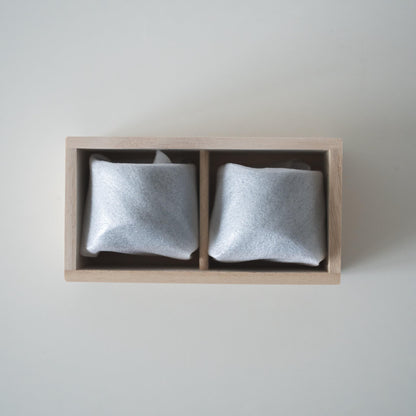 Gift set of two iron-colored sake cups, crafted using traditional Japanese roof tile techniques, presented in a paulownia wood box.