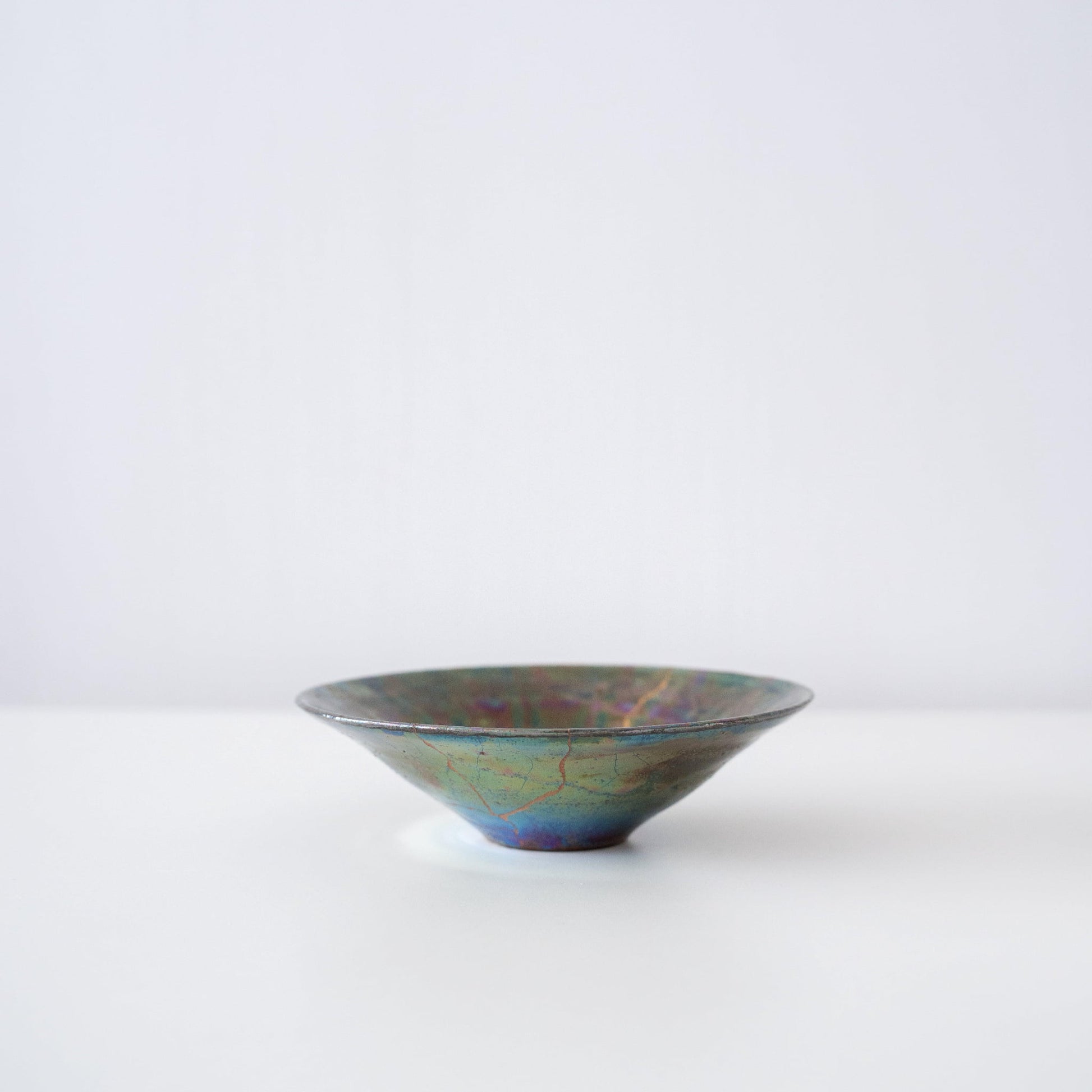 Vue de côté du bol Kintsugi "Nébuleuse Verte" sur fond blanc