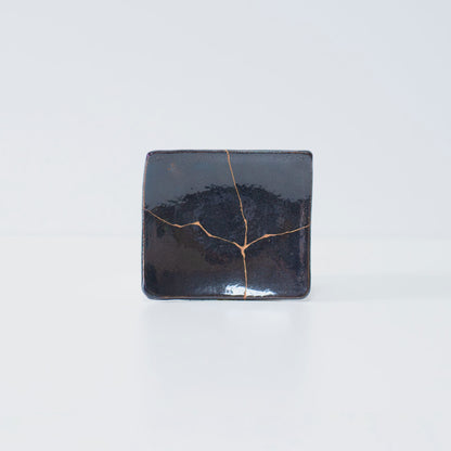 Side view of Kintsugi Square Plate "Jet Black Lighting" 01 in a white background