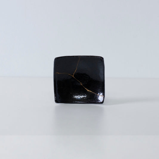 Side view of Kintsugi Square Plate "Jet Black Lighting" 02 in a white background