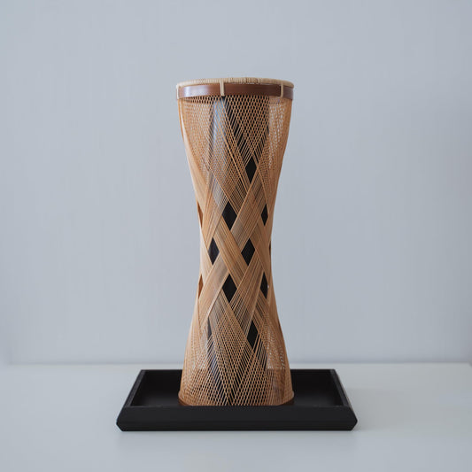 Handcrafted Japanese bamboo Ikebana vase, meticulously crafted by skilled artisans using traditional bamboo weaving techniques, showcasing the natural beauty and elegance of bamboo.
