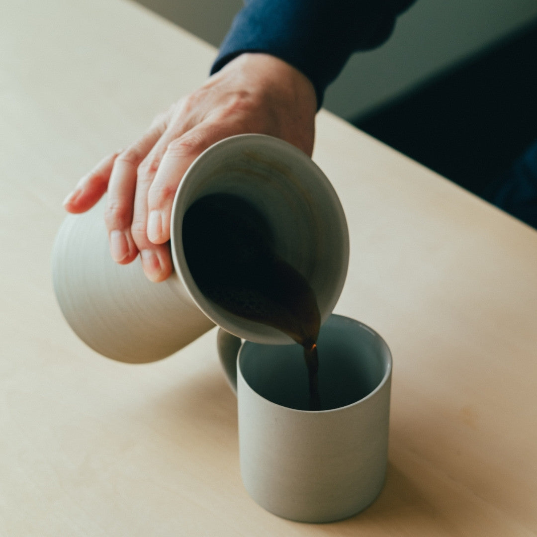Pouring coffee from Japanese pottery server into coffee mug | Japandi kitchen coffee set