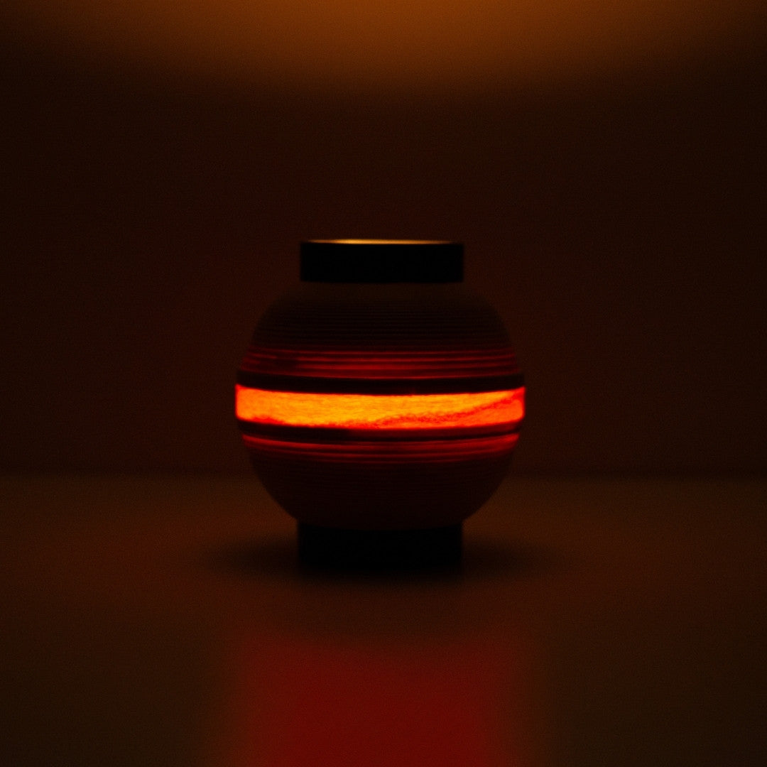 Japanse tafellamp met gloeiende ring van licht, die een vlamachtige gloed werpt voor sfeervolle interieurs.