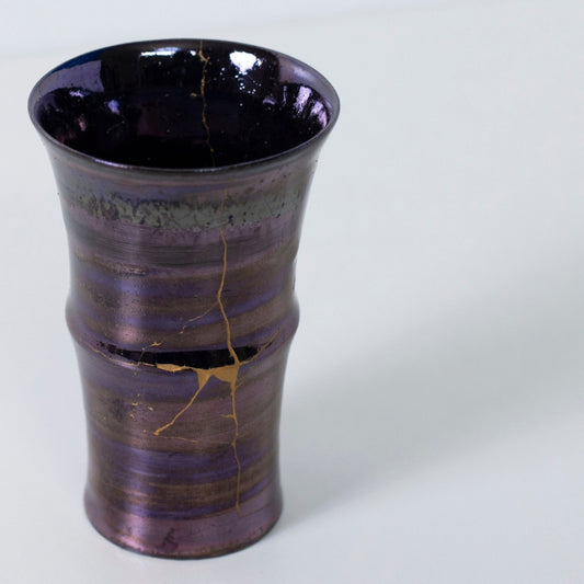 Top view of glossy purple kintsugi cup with dramatic golden crack | wabi sabi pottery