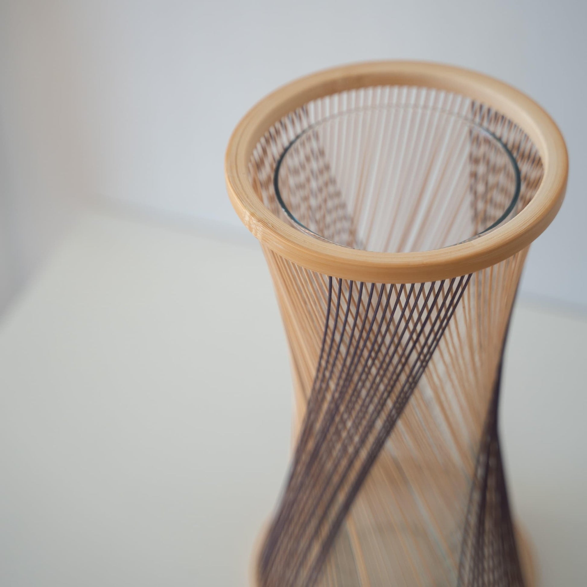 Handcrafted Japanese bamboo Ikebana vase, meticulously crafted by skilled artisans using traditional bamboo weaving techniques, showcasing the natural beauty and elegance of bamboo.