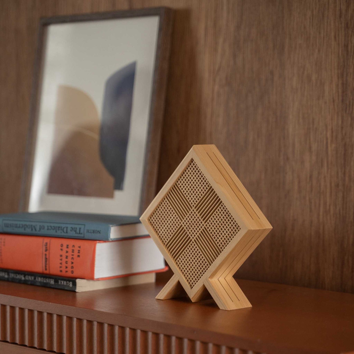Close-up of Japanese wood table lamp "Kanata" standing as an elegant wabi sabi decor on a mid-century modern style console table.