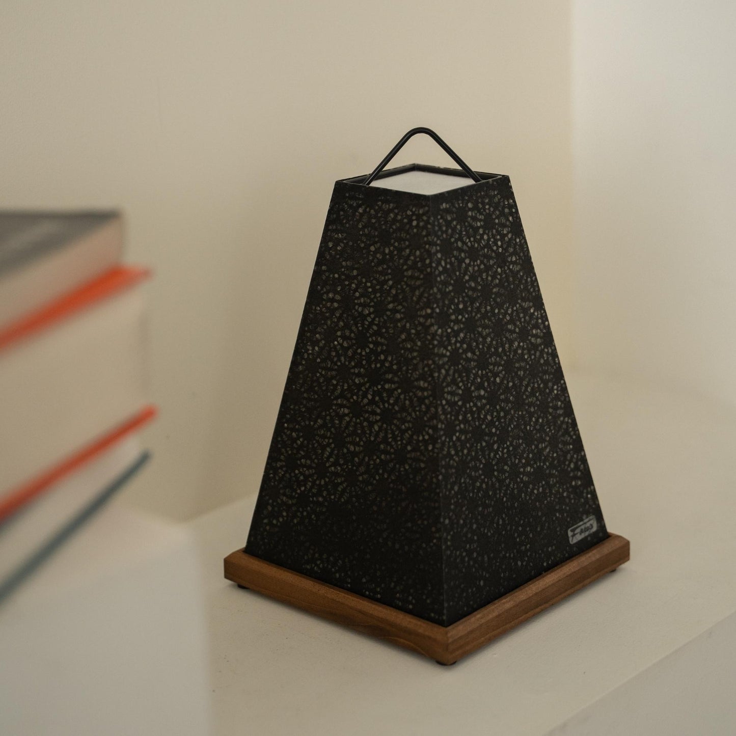 Close-up of unlit Japanese paper table lamp "Mini Akari" Black, showing intricate lace patterns for Japandi decor.