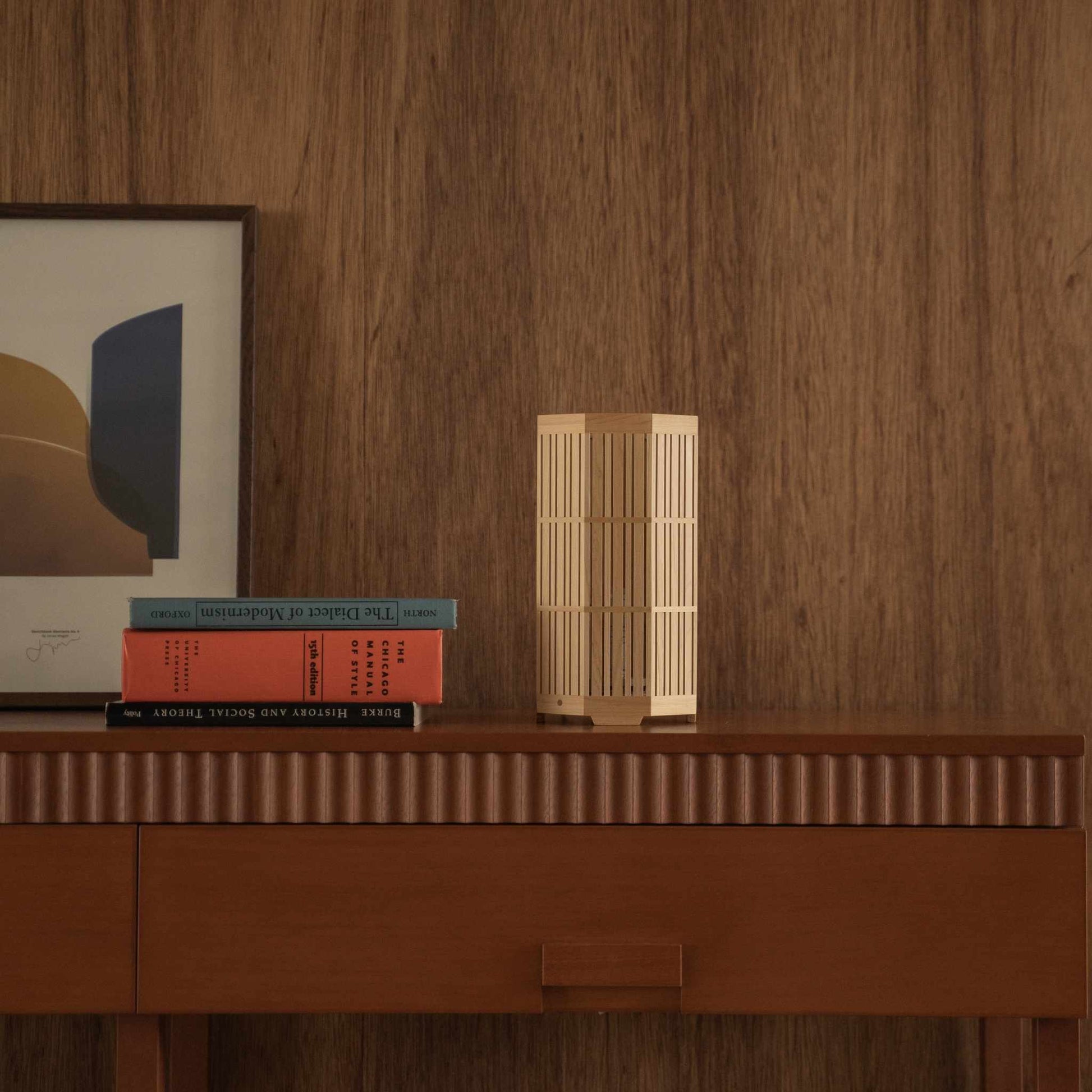 Unlit Japanese wood table lamp "Kagayaki" displaying fine kumiko woodworking on a mid-century modern wooden console table.