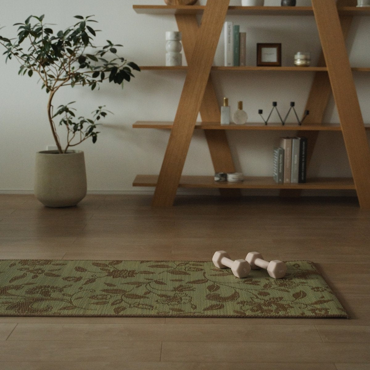 Japanese Tatami Yoga Mattress "Sarasa" Beige with modern botanical pattern on a wooden floor in a tranquil Japandi mindful home corner.
