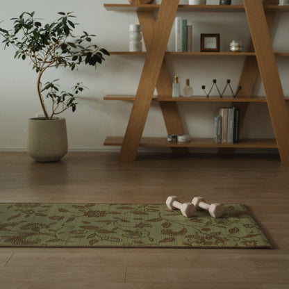 Japanese Tatami Yoga Mattress "Sarasa" Beige with modern botanical pattern on a wooden floor in a tranquil Japandi mindful home corner.