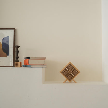 Unlit Japanese wood table lamp "Kanata" acting as a wabi sabi decor on a white Japandi style console table.