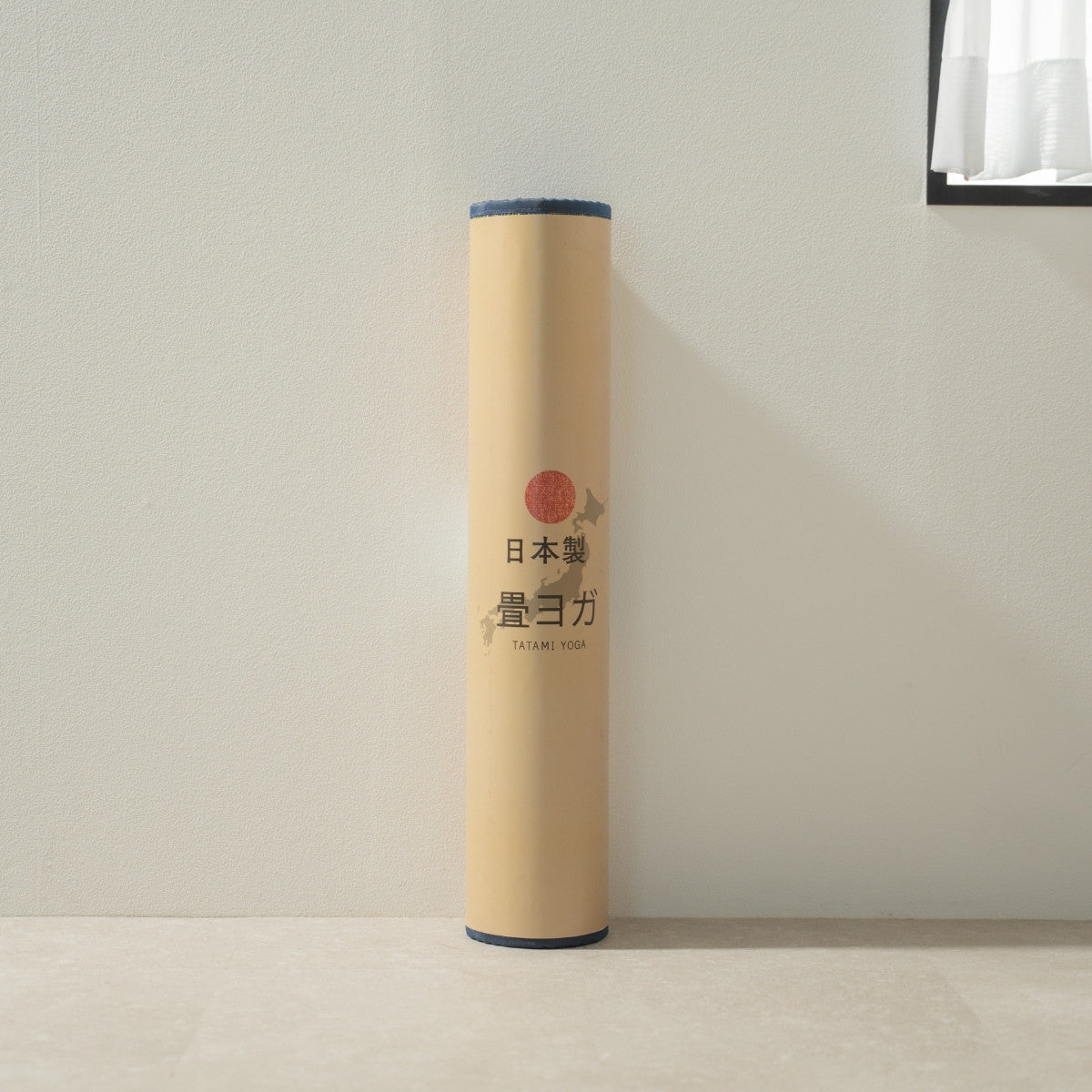 Packaged Japanese Tatami Yoga Mattress "Marble" Blue standing by a white wall, ready for your daily mindful meditation.