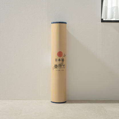 Packaged Japanese Tatami Yoga Mattress "Marble" Blue standing by a white wall, ready for your daily mindful meditation.