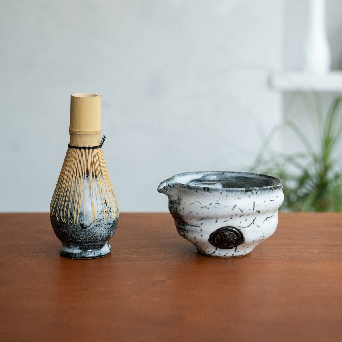 Creative Cloud spouted matcha bowl and Japanese matcha whisk stand on a wooden table to elevate your morning tea ritual