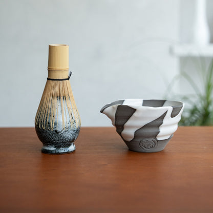 White Flow spouted matcha bowl and Japanese matcha whisk stand on a wooden table for a relaxing matcha latte routine