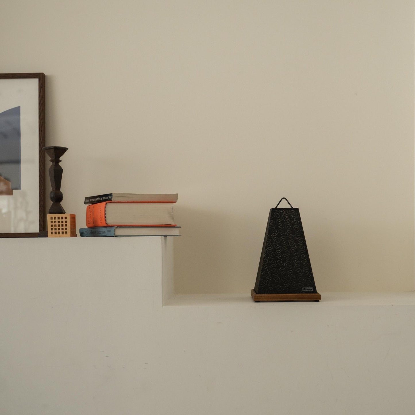 Unlit Japanese paper table lamp "Mini Akari" Black placed on a white console table in a minimalist Japandi living room.