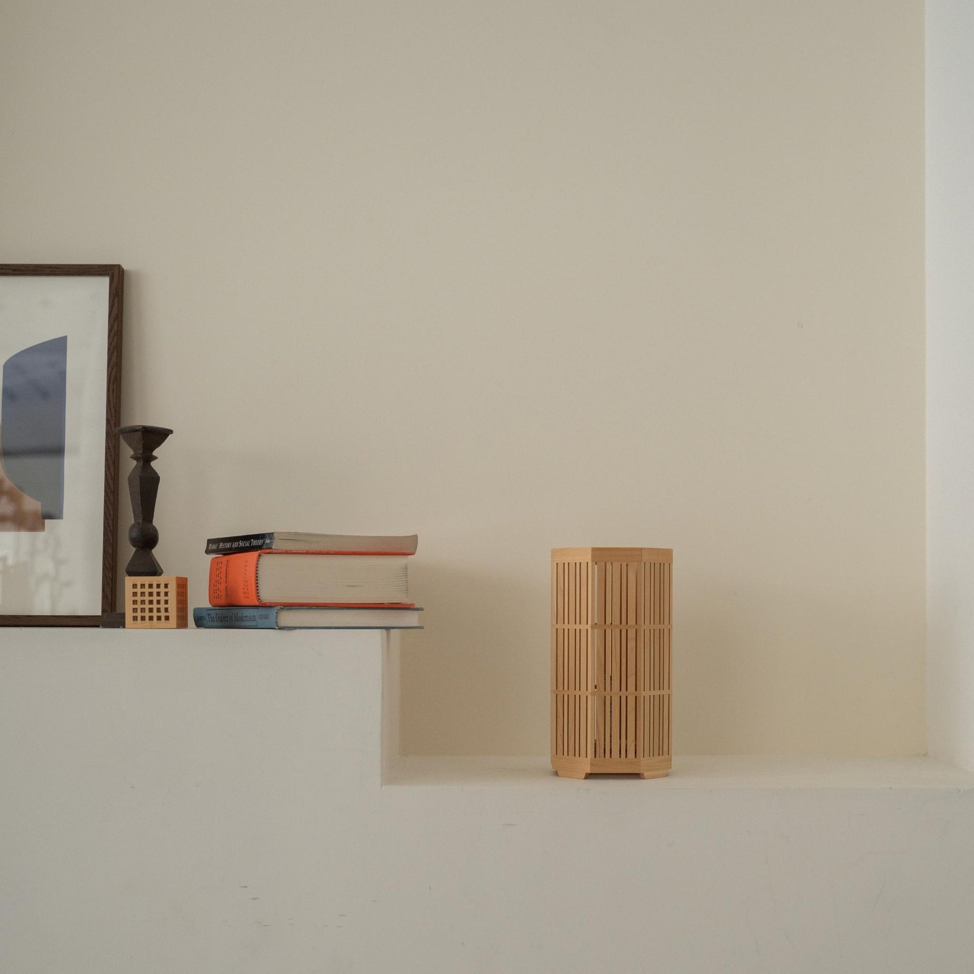 Unlit Japanese wood table lamp "Kagayaki" acting as a Japanese decor on a white Japandi style console table.
