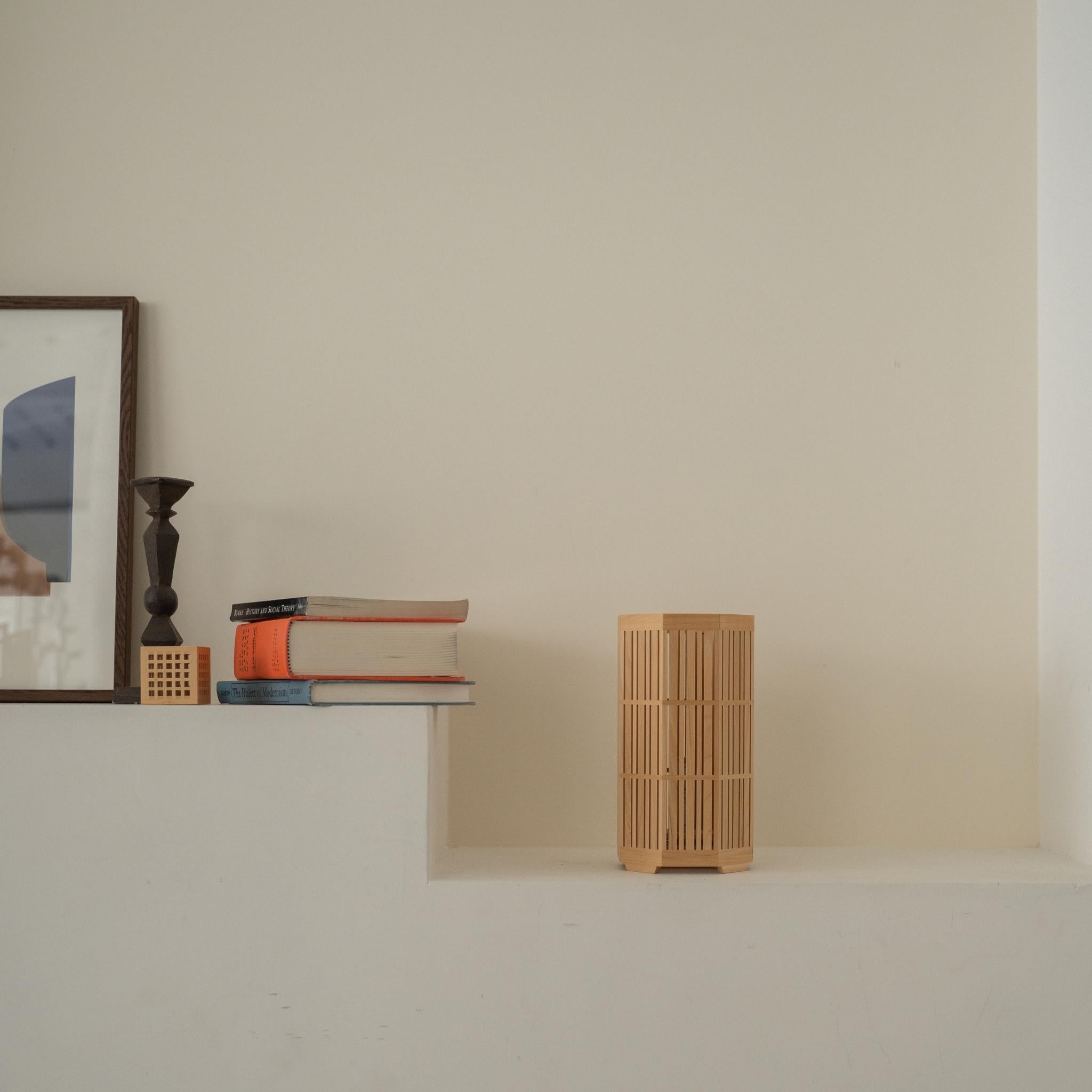 Unlit Japanese wood table lamp "Kagayaki" acting as a Japanese decor on a white Japandi style console table.