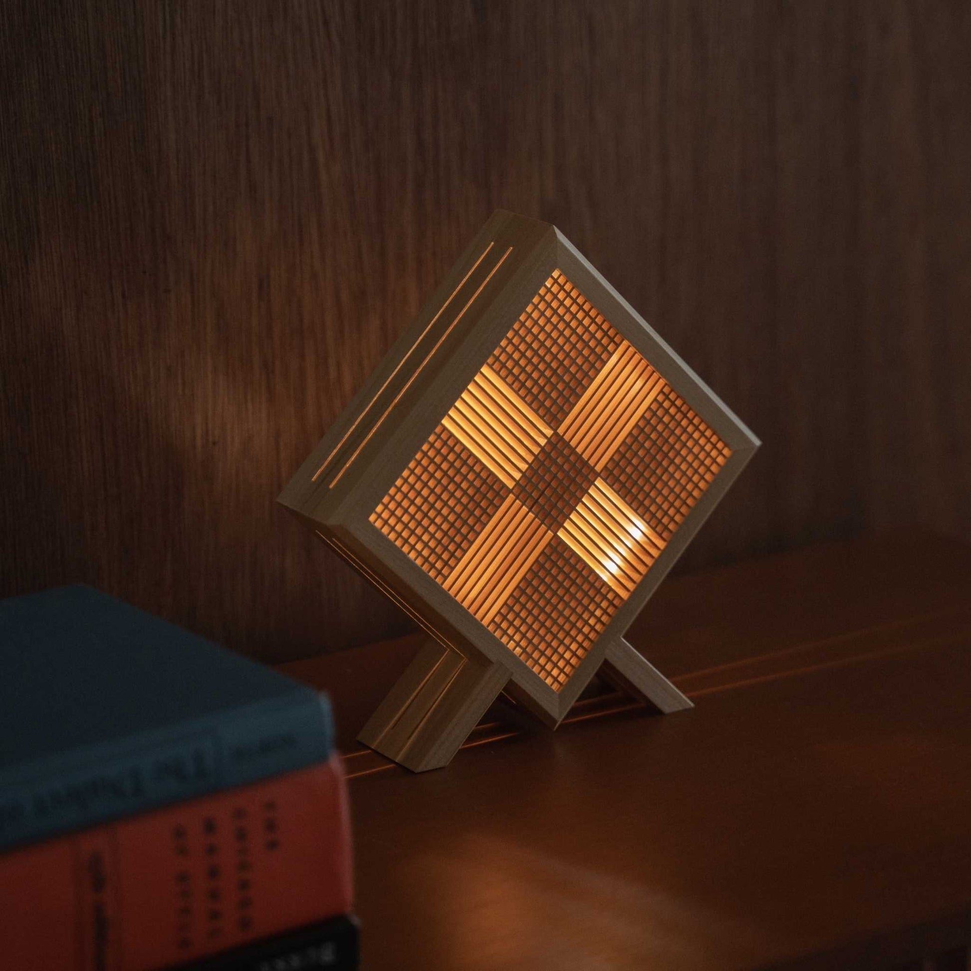 Close-up of lit Japanese wood table lamp "Kanata" serving as a cozy accent lamp on a mid-century modern style console table.