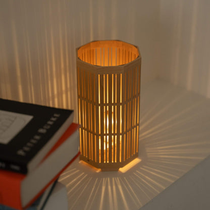 Glowing Japanese wood table lamp "Kagayaki" serving as an ambient lamp, projecting radial shadows to a Japandi style room.
