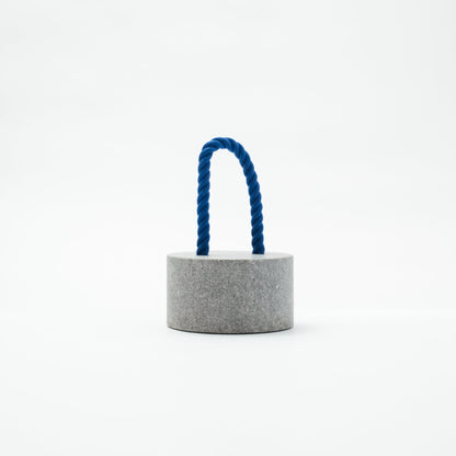 Japanese Aji Stone Doorstop "FUJ" in gray, front view.