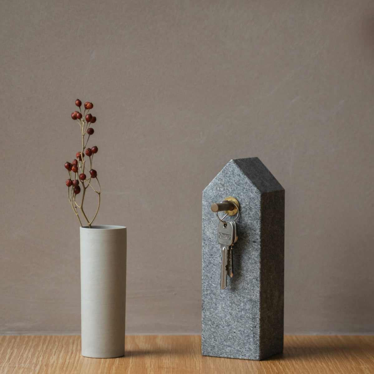 Japanese Aji Stone Key Holder in natural stone styled in a console table setting, console scene view.