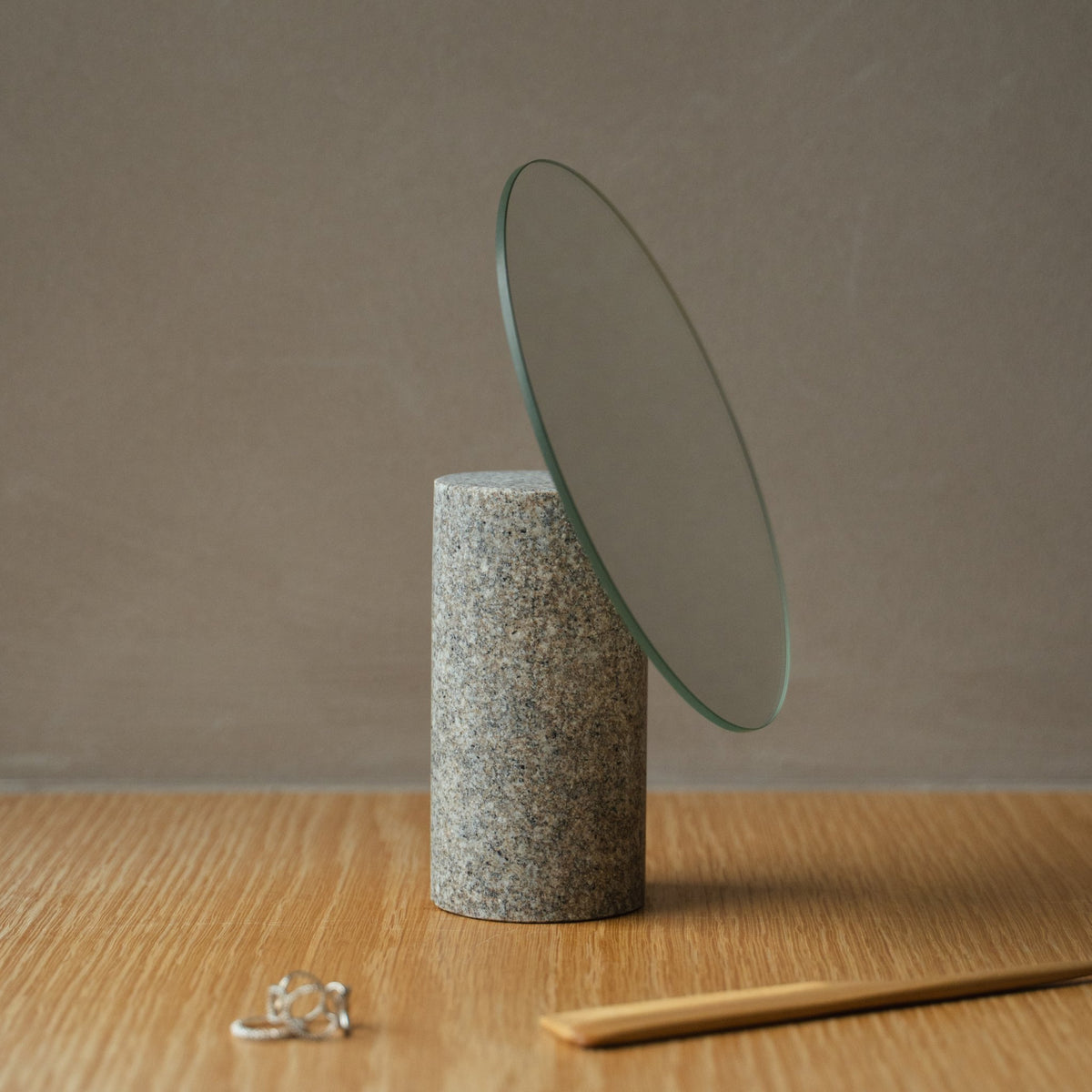 Japanischer Aji-Stein-Tischspiegel aus Naturstein, arrangiert auf einem Konsolentisch, Ansicht der Konsolenszene.