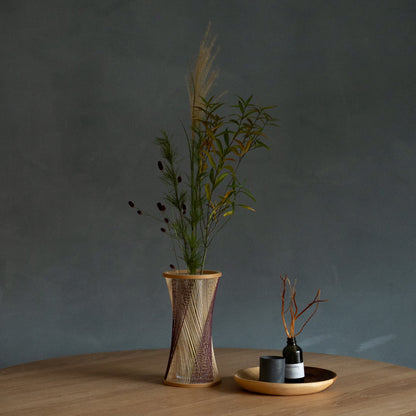 Japanese Bamboo Flower Vase "Fleeting Moment" in brown & purple styled in a dining room setting, dining scene view.