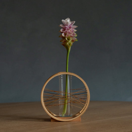 Japanese Bamboo Flower Vase "Flowing Wind" in brown styled in a dining room setting, dining scene view.