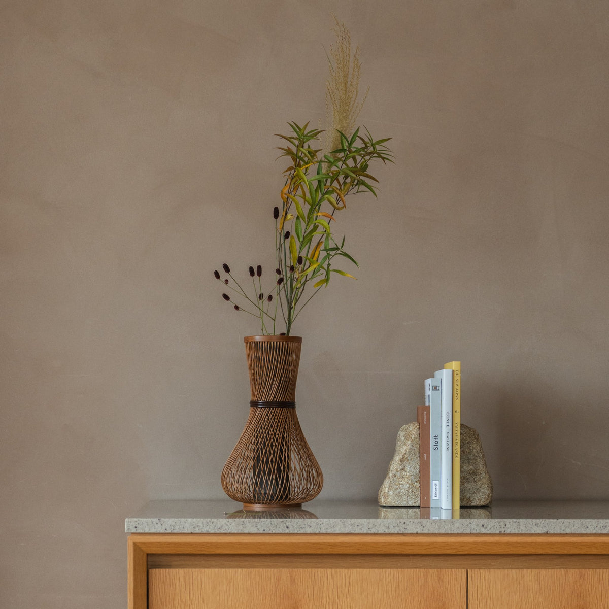Japanese Bamboo Flower Vase "Fukuju" in brown styled in a console table setting, console scene view.
