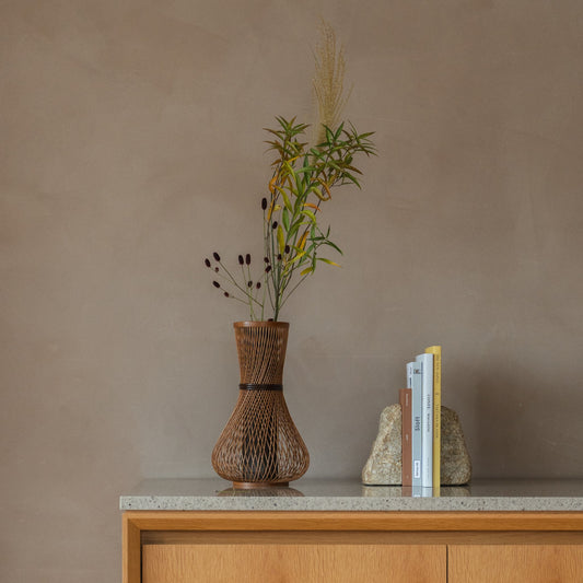 Japanese Bamboo Flower Vase "Fukuju" in brown styled in a console table setting, console scene view.