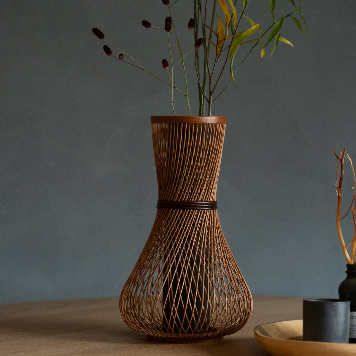 Japanese Bamboo Flower Vase "Fukuju" in brown styled in a dining room setting, dining scene view.