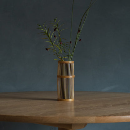 Japanese Bamboo Flower Vase "Shiori" in brown styled in a dining room setting, dining scene view.